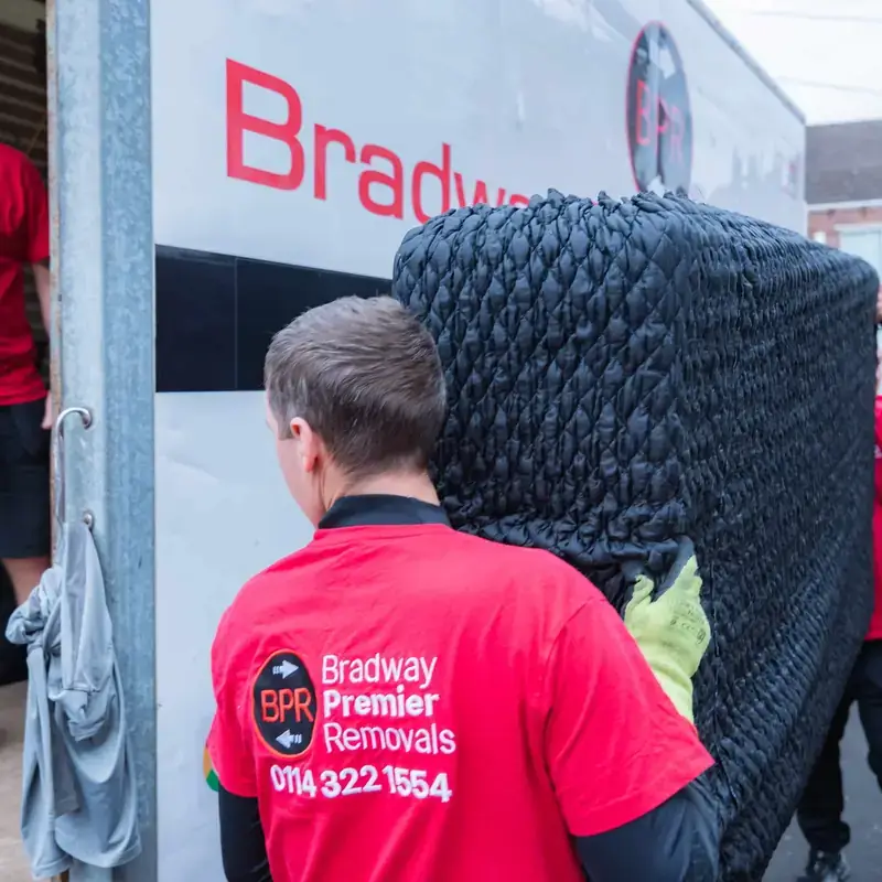 Bradway Premier Removals crew carrying protected furniture to the removals van during a house removal in Sheffield