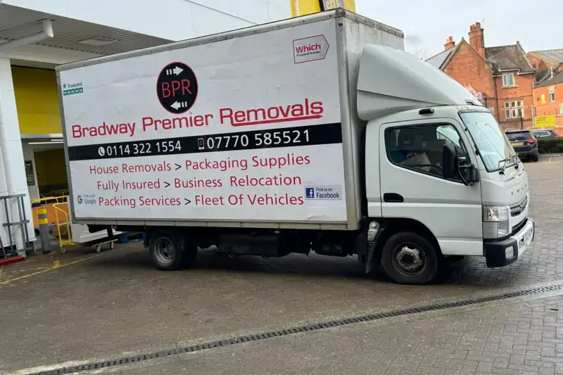 White Bradway Premier Removals removals van parked in front of a building