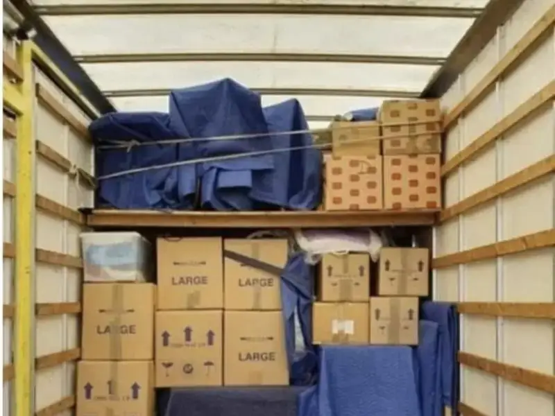 Neatly loaded removals lorry with boxes and blue wrapped furniture, Bradway Premier Removals